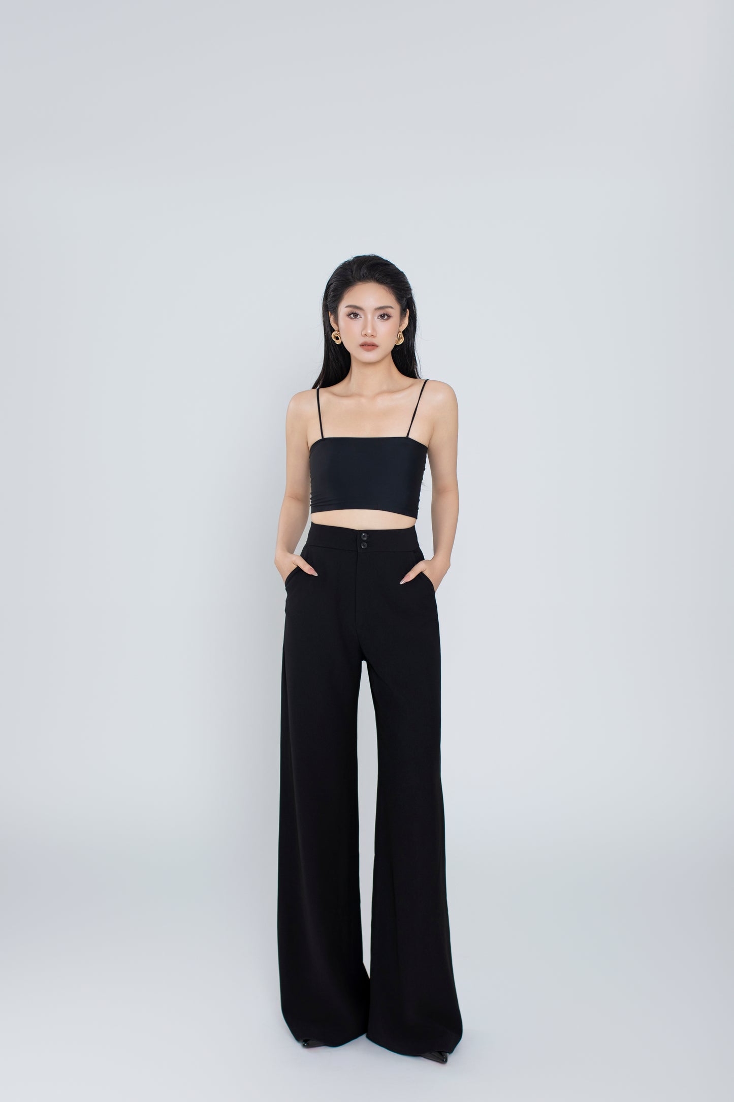 Front view of Freya high-waisted tailored pants in black