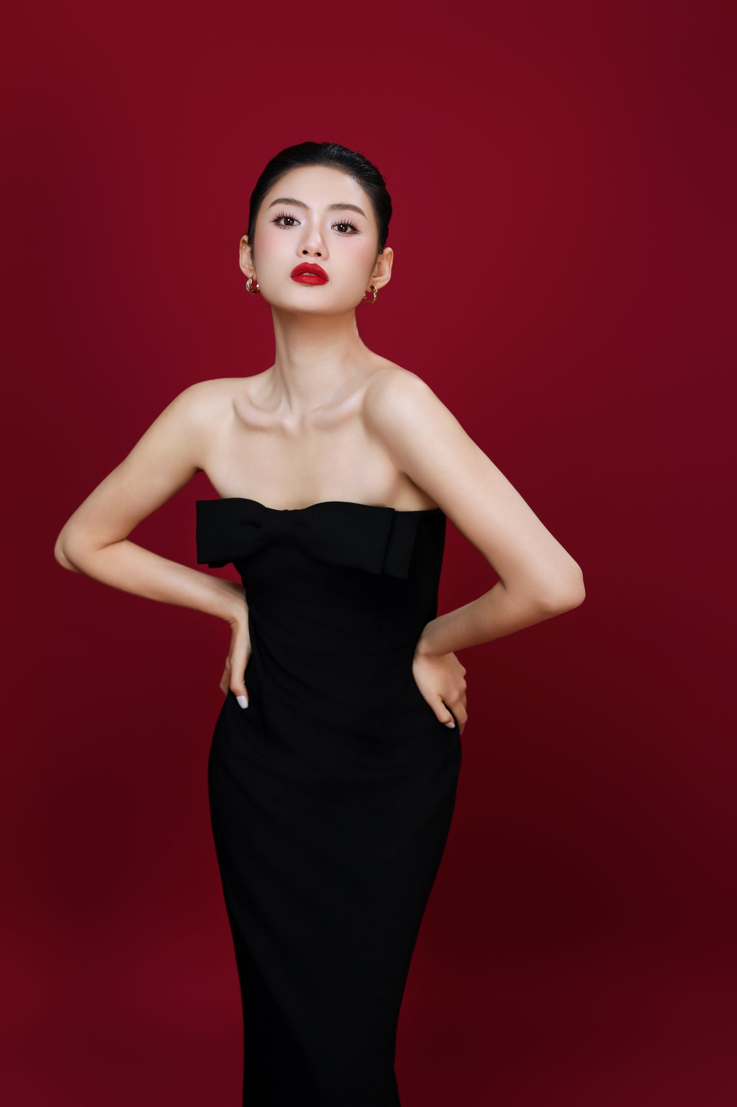 Close-up of Amelia dress bodice with subtle bow detail and stretchy fabric