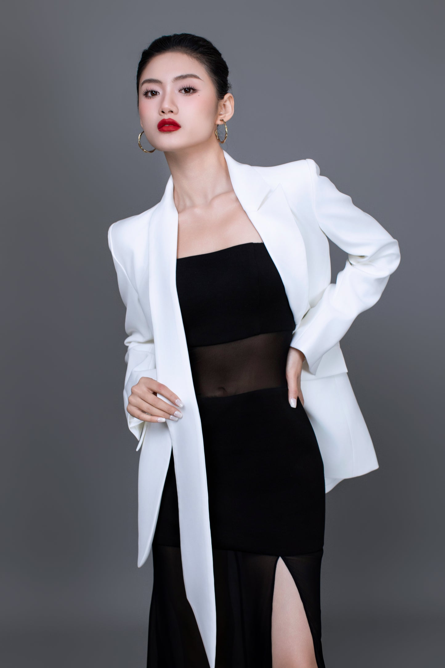Model wearing Ellen blazer styled with Dahlia black dress for a chic, versatitle look
