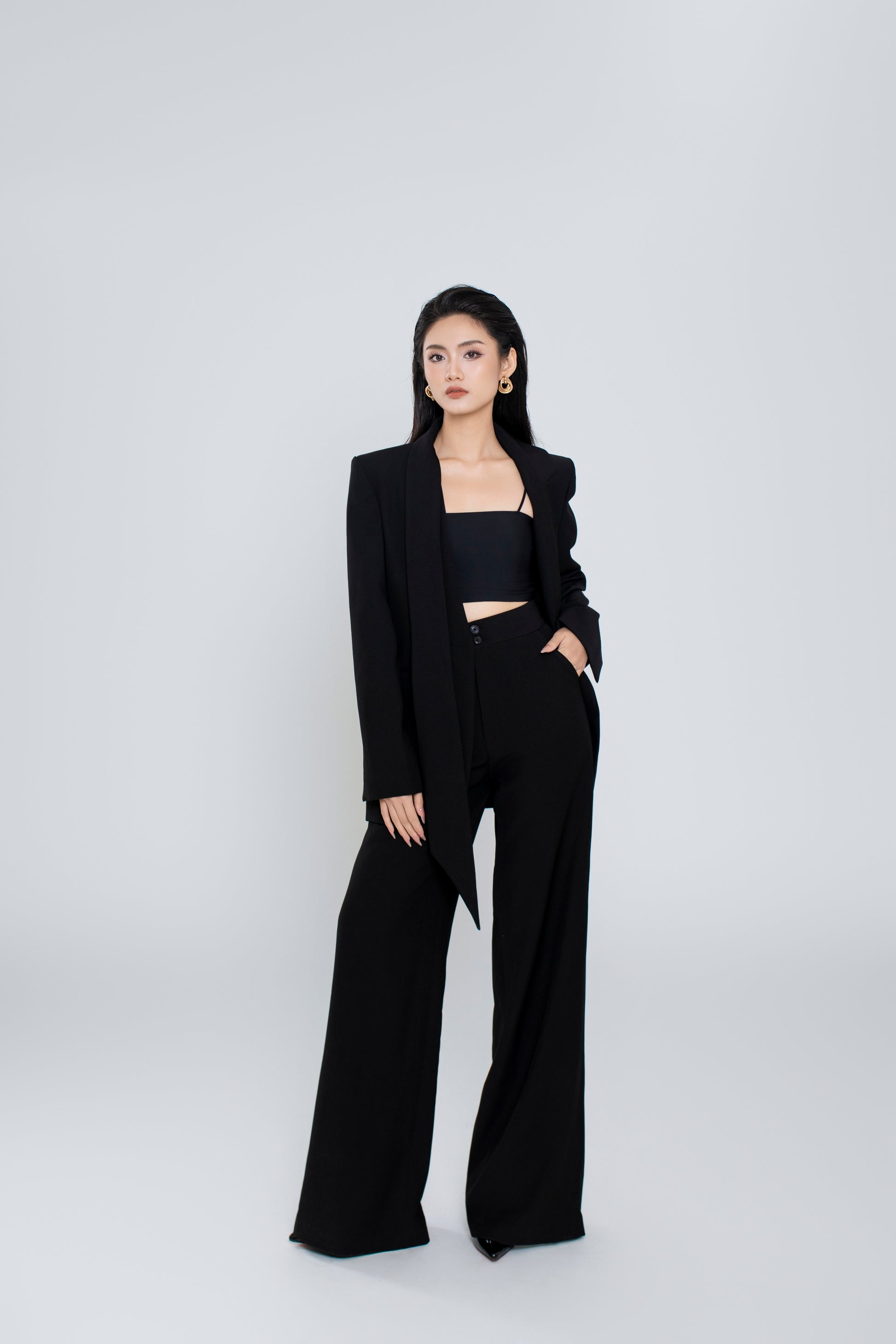 Model wearing Ellen blazer styled with matching Freya pants for a chic look