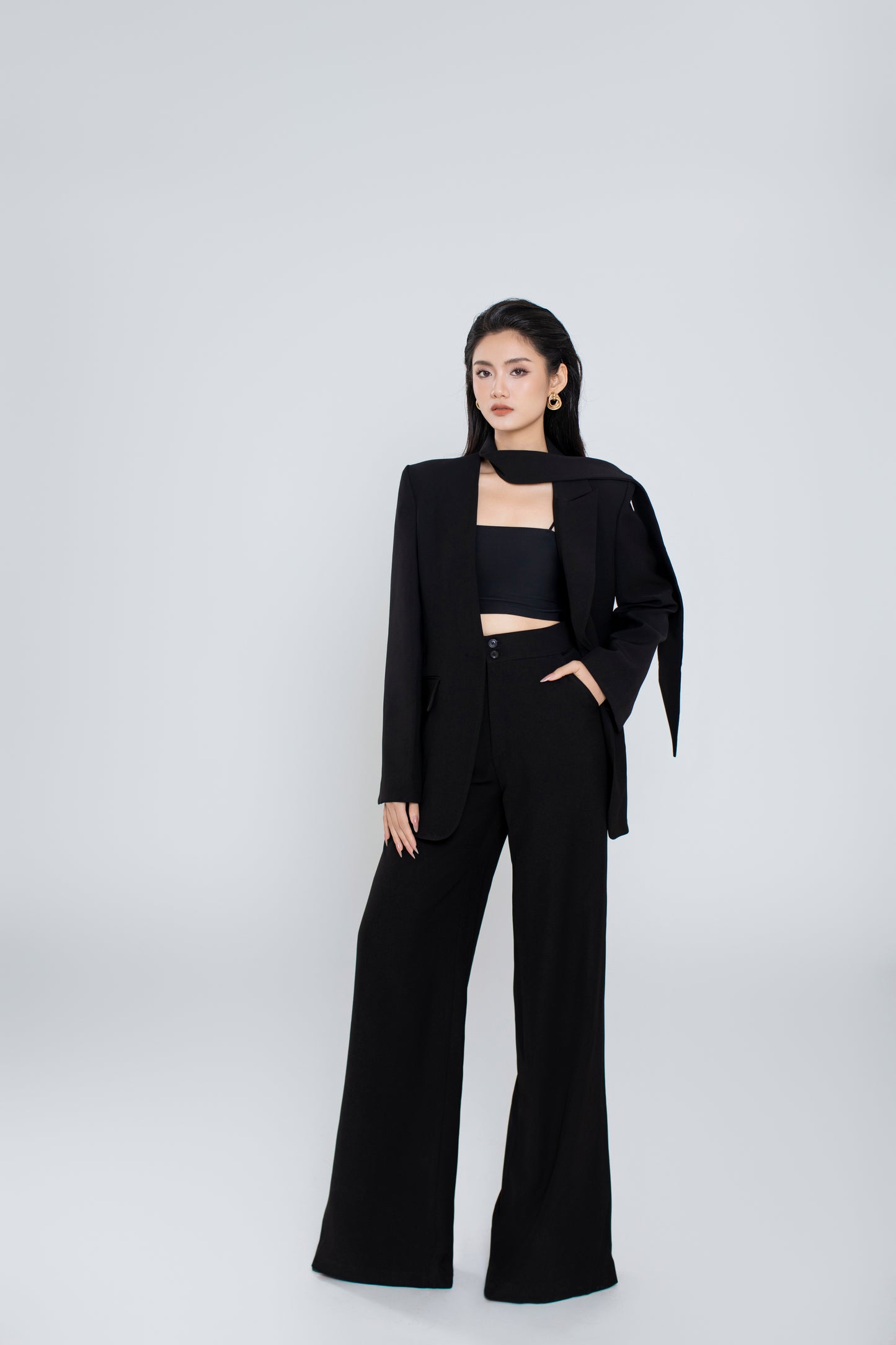 Model wearing Freya black pants styled with minimalist black Ellen blazer for a powerful office look