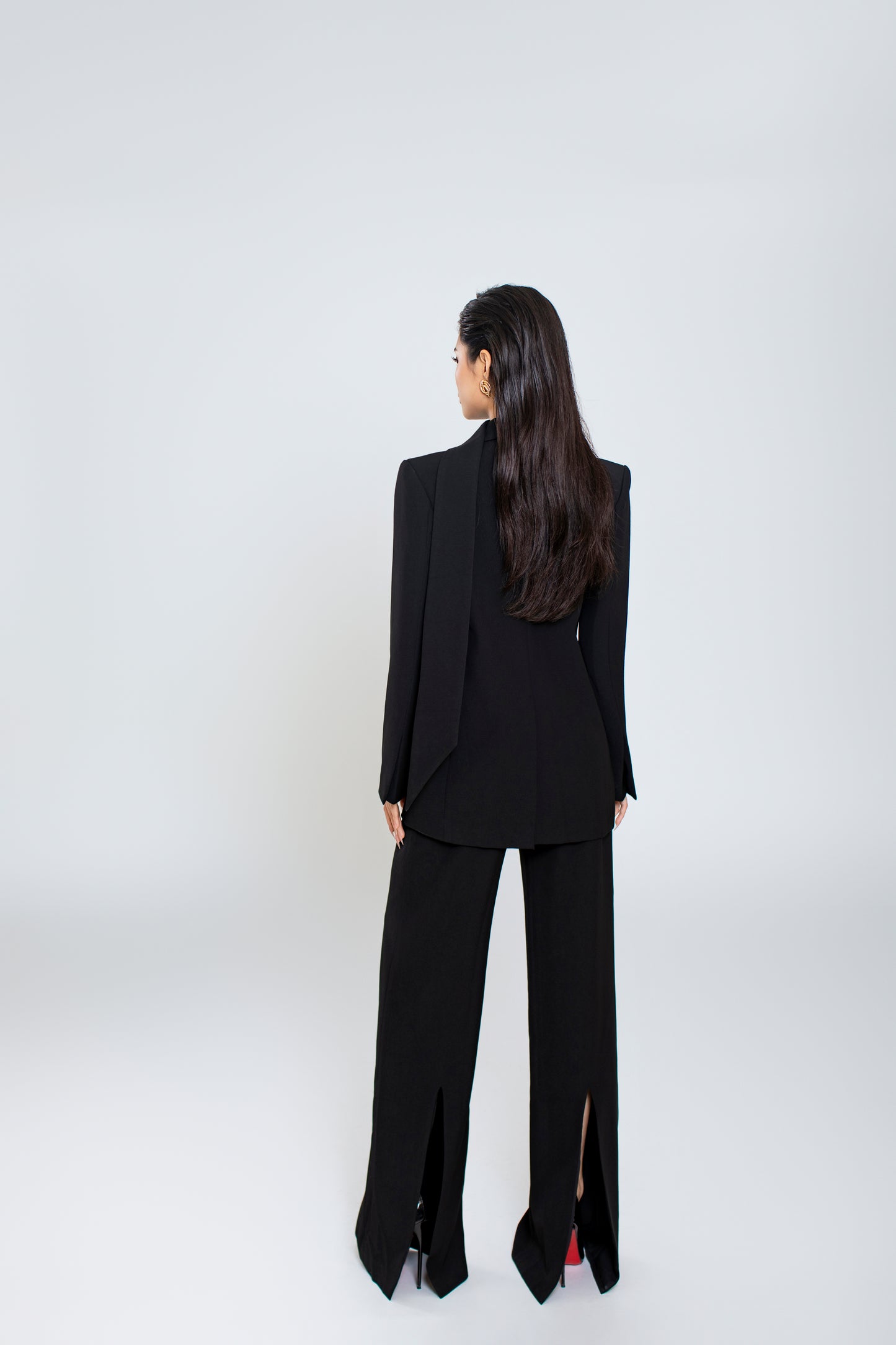Back view of Ellen blazer with clean lines and minimalist design, pair with black Freya trousers with seamless finish and back slit

