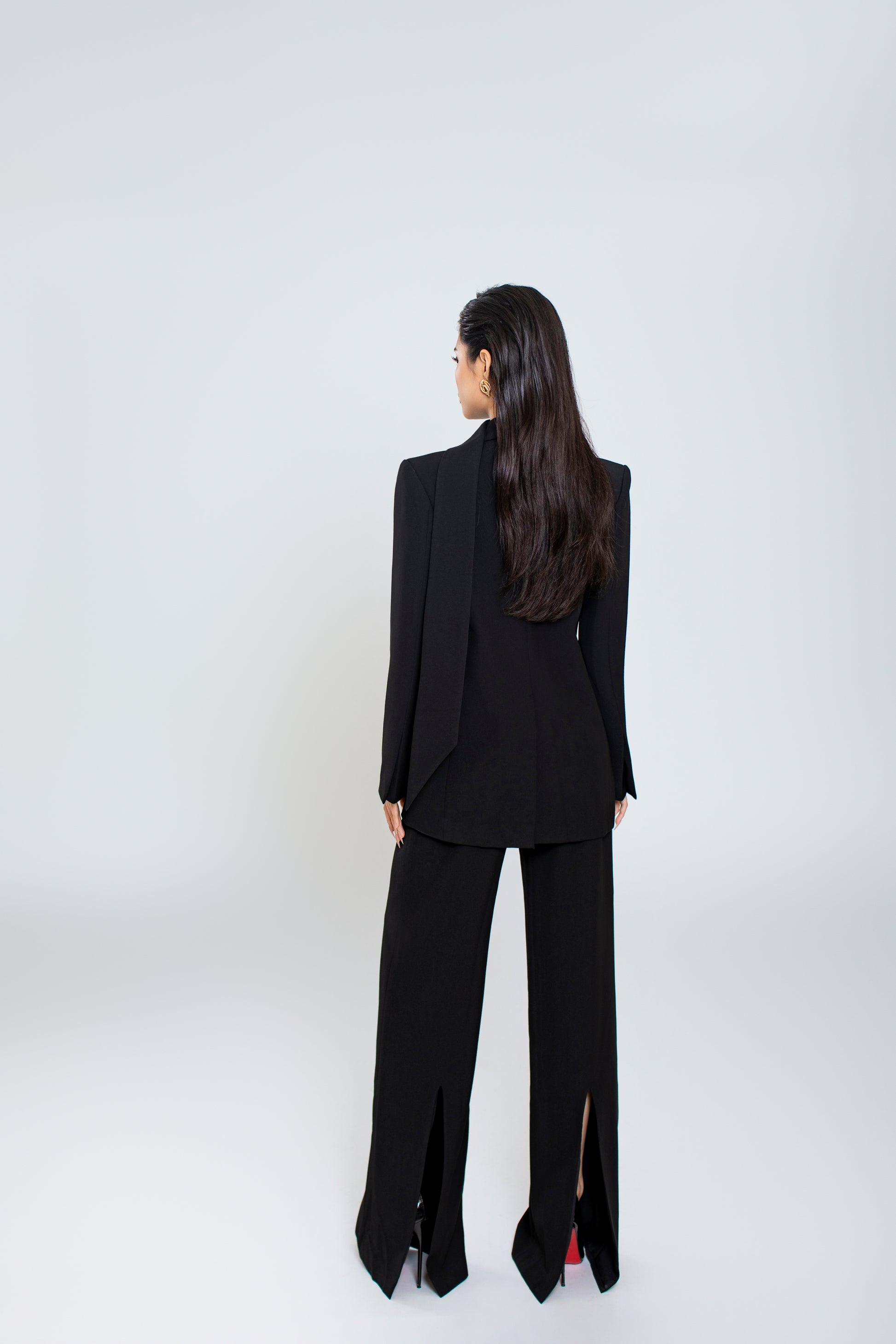 Back view of Ellen blazer with clean lines and minimalist design, pair with black Freya trousers with seamless finish and back slit

