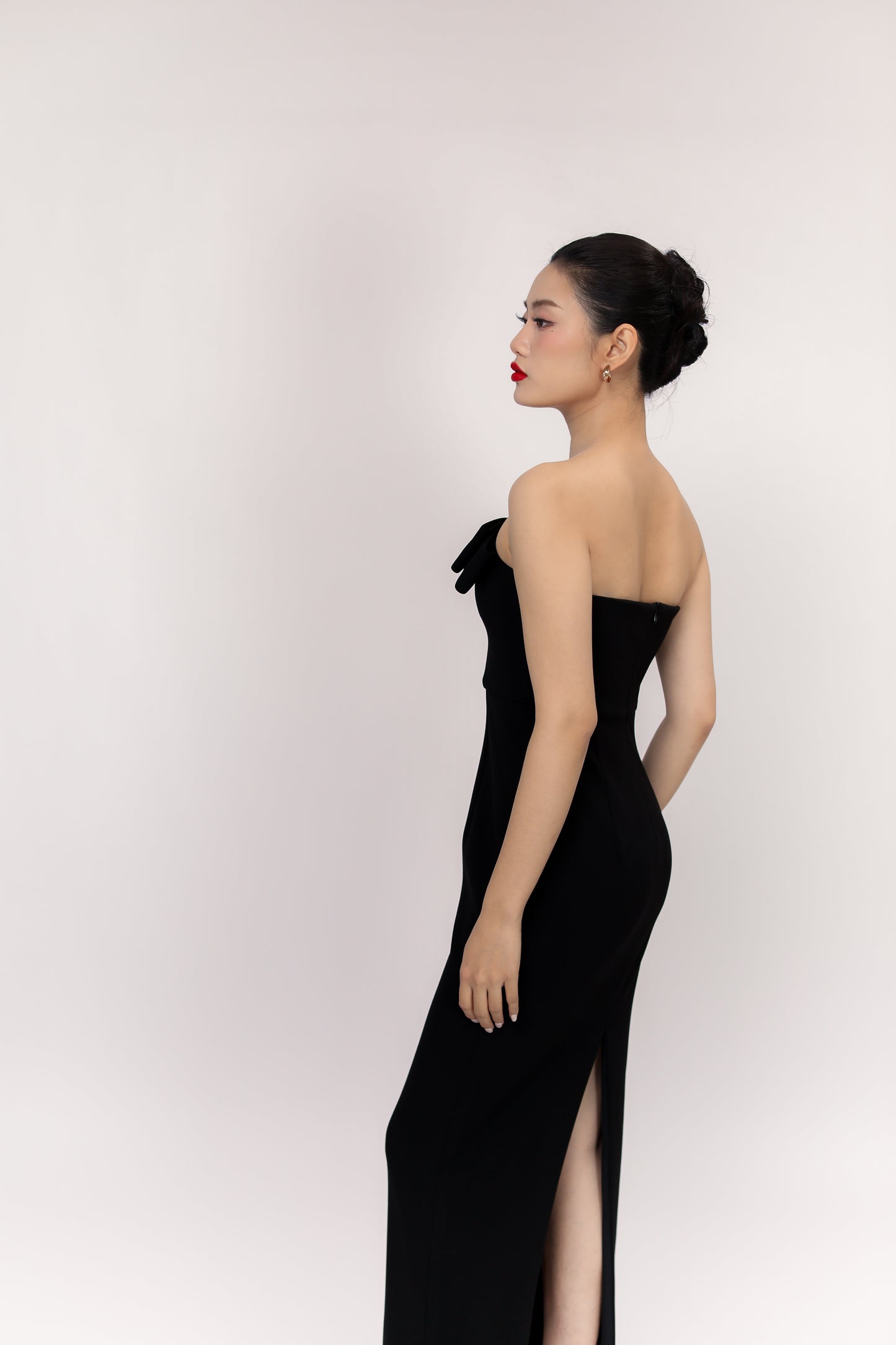 Side view of Amelia dress showcasing back slit and high-quality fabric texture