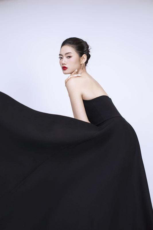 Side profile of Diana black dress showcasing flattering fit and flare silhouette