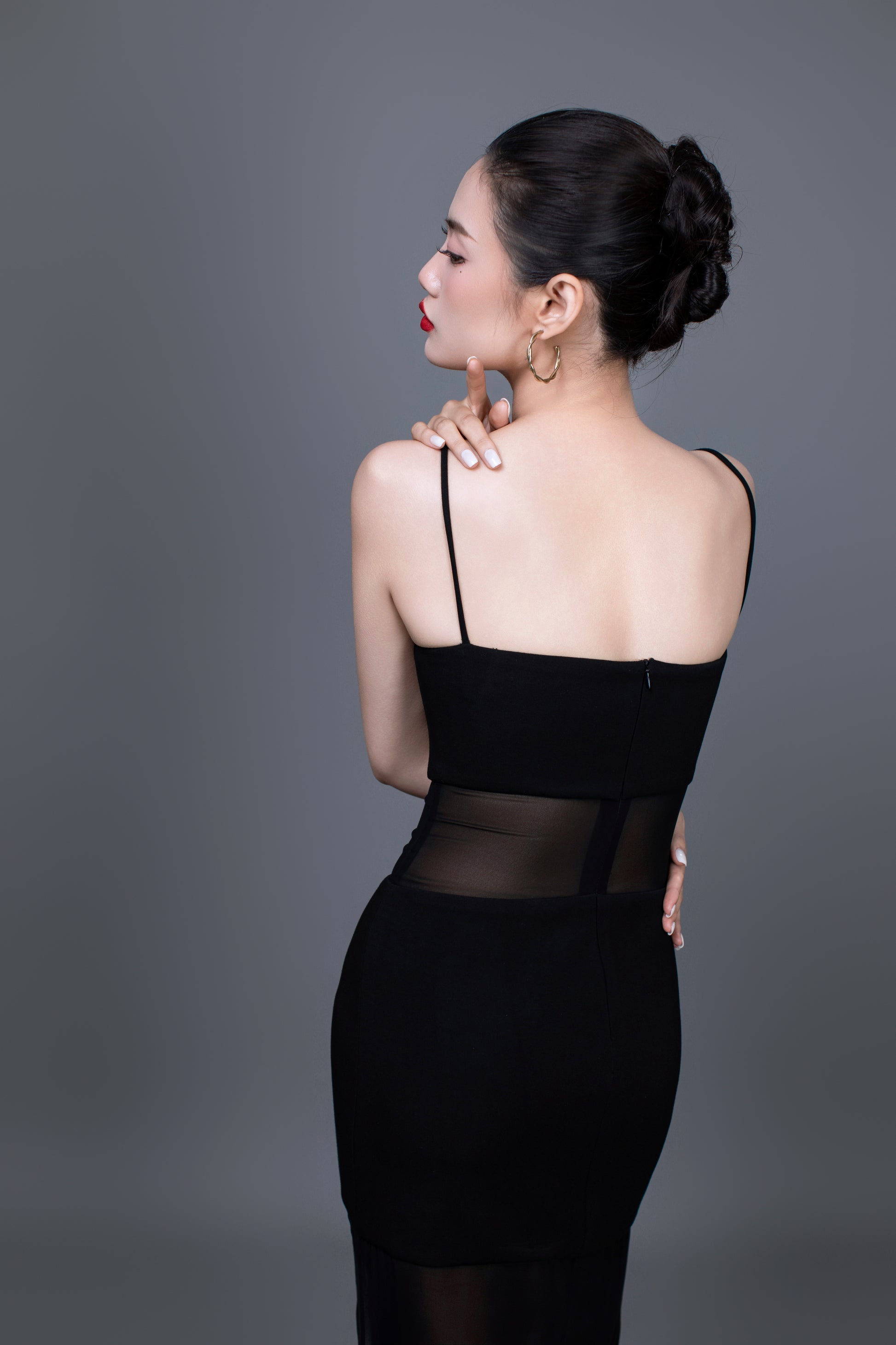 Back view of Dahlia dress with elegant draping and subtle train