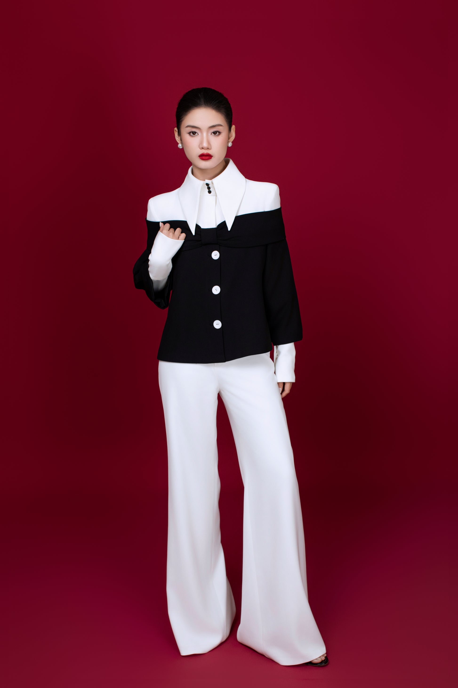 Model wearing Grace two toned top styled with monochrome elegant outfit